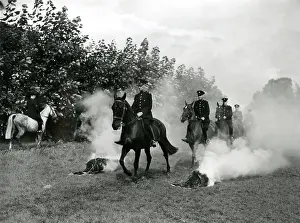 Metropolitan Police officers on horseback in a field