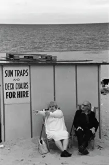 Middle Aged: Middle-aged couple on deckchairs at the seaside