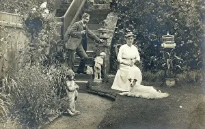 Birdcage: Middle aged couple and a dog in a garden