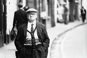 Middle Aged: Middle-aged man walking down a street