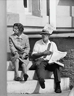 Fake: Middle-aged man and woman sitting on steps, Blackpool
