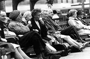 Keighley: Middle-aged people eat ice cream on a bench