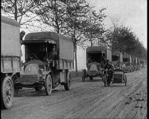 Military Lorries Driving Along A Road