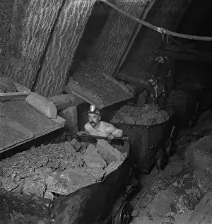 Hecla: A miner working a mine underground, loading ?