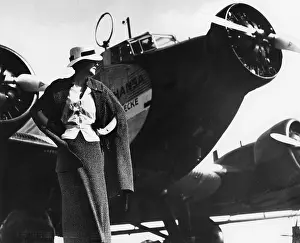 Apparel: Model in front of an airplane, 1935