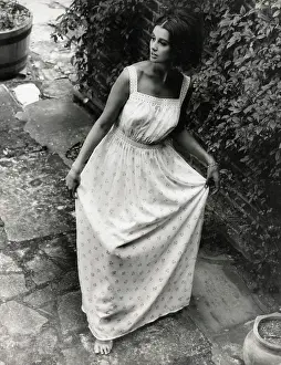 Sophistication: Model in a garden setting wearing a light summer dress