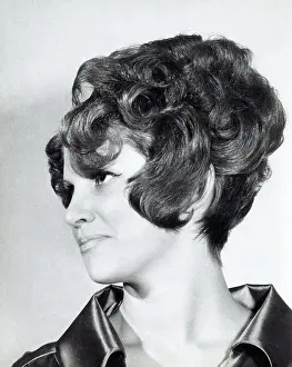 Elaborate: A model with hair coiffured with an elaborate curl effect