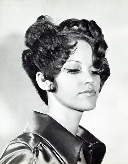 Elaborate: A model with hair coiffured with an elaborate curl effect