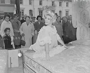 Babydoll: Model poses on bed in shop window, Bexley