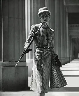 Mesh: Model in a sharp suit carrying an umbrella