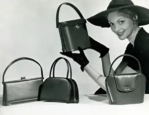 Showcasing: A model showcasing four elegant leather handbags