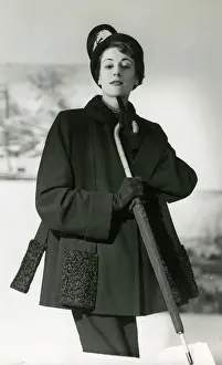 Sophistication: Model in smart black coat, fancy coat and umbrella