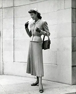 Pleated: Model wearing two-piece suit - jacket and long pleated skirt