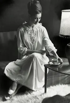 Bearskin: Model in a white nightgown with cup of morning tea