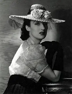 Mesh: Model in wide-brimmed straw hat and pale blouse