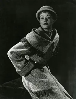 Tassles: Model in woollen coat with wide collar and cuffs