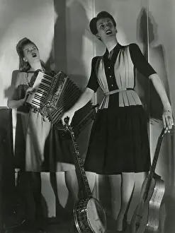 Pleated: Two models in musical pose
