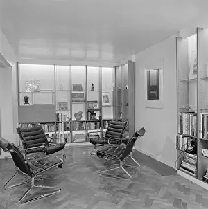Integral: A modern interior with integral shelving and leather arm chairs