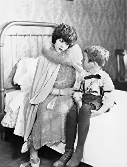 Disciplining: Mom having talk with son on bed