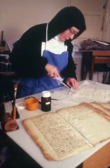 Conservator: Monastic life - nun conserving ancient historic documents