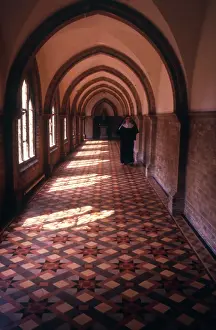 Colin Horsman: Monastic life - nun walking along a tiled corridor