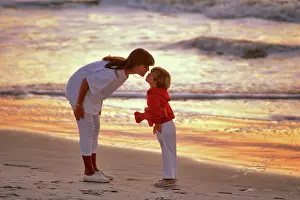 Timeless: Mother Bending to Kiss Son on Forehead While Walking on B