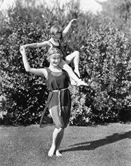 Ecovgc0176: Mother and daughter doing acrobatics in the back yard