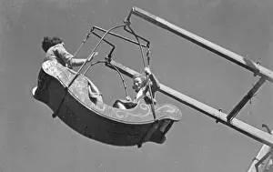 Swingboat: Mother and daughter on a fairground ride