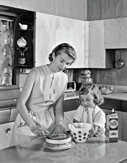 Frosting: Mother and Daughter in Kitchen Frosting Double Layer Ca
