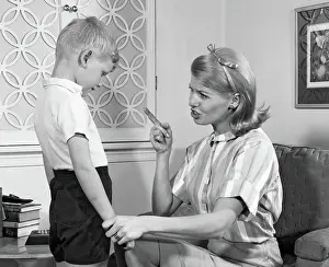 Disciplining: Mother Disciplining Her Son by Talking Harshly and Shaking H
