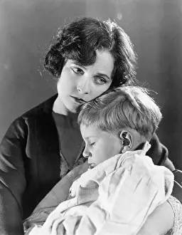 Woeful: Mother holding her sleeping son