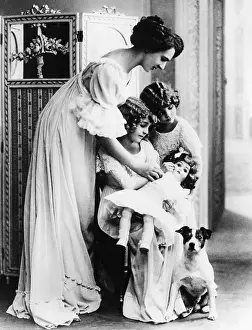 Learn: Mother instructs daughters in child care, 1910