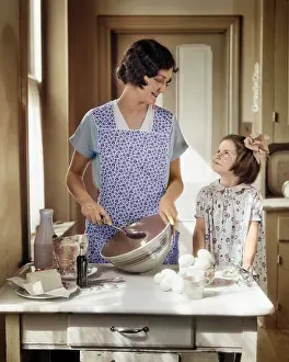 Moms: Mother with Mixing Bowl in Kitchen Baking