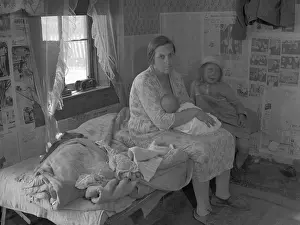 Ozarks: Mother nursing her infant on a bed with ?