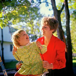 Moms: Mother Pushing Laughing Daughter
