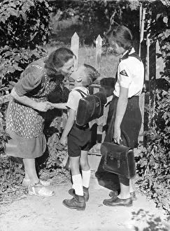 Auspices: A mother says goodbye to her children as they go to school