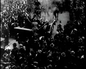 Motorcade: A Motorcade Passing Through A Large Crowd In