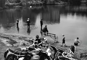 Propped: Motorcycle, bicycles and their owners at the pond