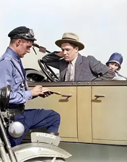 Violation: Motorcycle Policeman Writing a Speeding Ticket