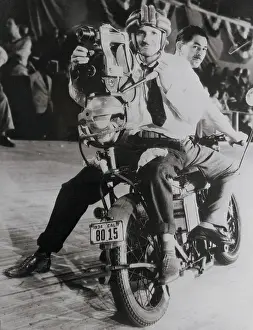 Backseat: A motorcycle race is being filmed