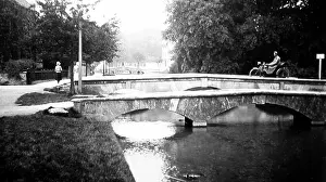 Motorcyclist: Motorcyclist on a bridge in Bourton on the Water