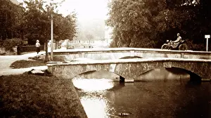 Motorcyclist: Motorcyclist on a bridge in Bourton on the Water