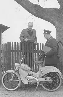 Foto: Motorized postman. Letter delivery by moped