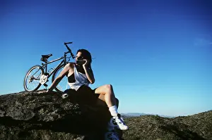 Cellular: Mountain Biker Using Cellular Telephone