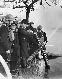 Nationalised: Mr Attlee attending hosepipe tests at Wimbledon, WW2