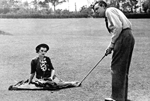 Putt: Mrs Charles Sweeny watching her husband play golf