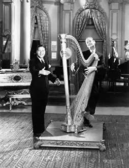 Harpist: Musician playing a harp