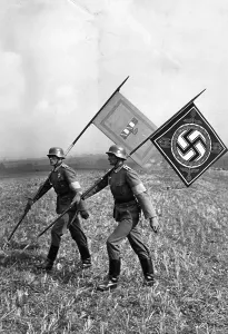 Stubble: Mussolini and Hitler standards at a maneuver, 1937