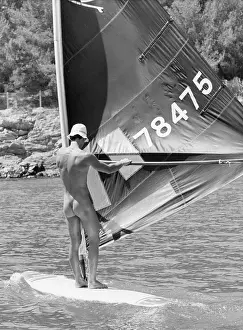 Holidaymaker: Naked holidaymaker on a windsurfer