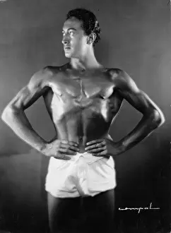 Straining: A naked man straining his muscles